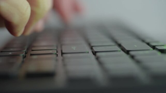 Hands typing on illuminated keyboard then punch, closeup of hands slamming keys with blue and red LED reflections, rapid motion and audible impact, tense desk atmosphere, late