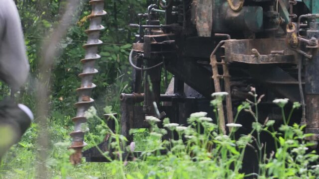 engineering geological surveys, environmental soil analysis, a drill drills into the soil