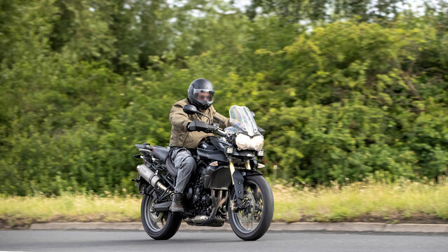 Stony Stratford,Bucks,UK - June 7th 2026:  2011  Triumph Tiger 800  motorcycle driving on a British road