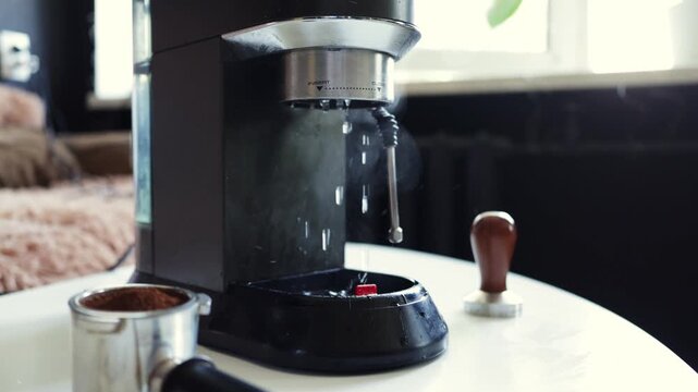Espresso machine brewing hot coffee, water dripping into portafilter