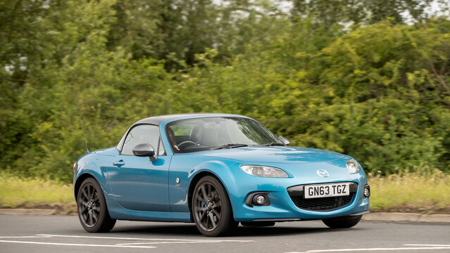 Stony Stratford,Bucks,UK - June 7th 2026: 2013 blue Mazda mx 5 i car driving on a British road