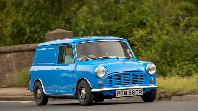 Stony Stratford,Bucks,UK - June 7th 2026: 1977 blue British Leyland Mini van car driving on a British road