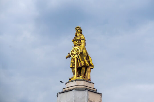 Soviet statue of woman, combine operator. Cloudy day