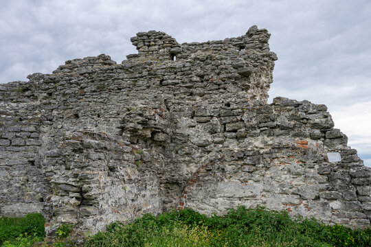the weathered, crumbling stone walls of an ancient castle ruin set against an overcast sky in Kremenets, Ukraine