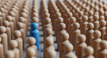 Obraz premium One blue wooden figurine standing out among rows of brown figurines