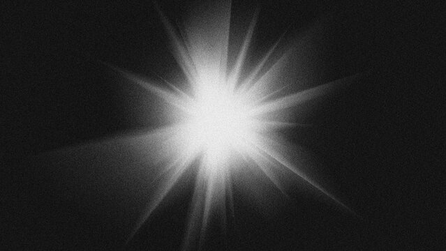 Bright starburst lens flare light effect on black background with grain texture.