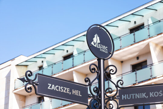 Wieniec-Zdroj, Poland - March 9, 2026. Closeup of the logo and direction signs at Wieniec-Zdroj health resort.