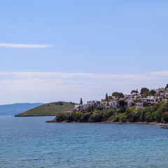 Naklejka premium Bitez, Bodrum showcasing traditional white houses on the coastline overlooking the clear turquoise Aegean Sea
