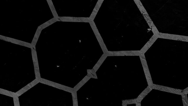 Abstract geometric pattern with hexagonal outlines, dark background, worn texture, and subtle scratches. Grunge texture background animation.