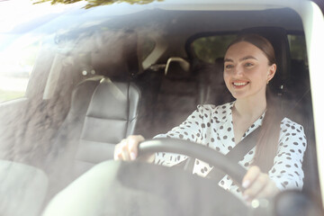 Naklejka premium Woman driving modern car, view through windshield