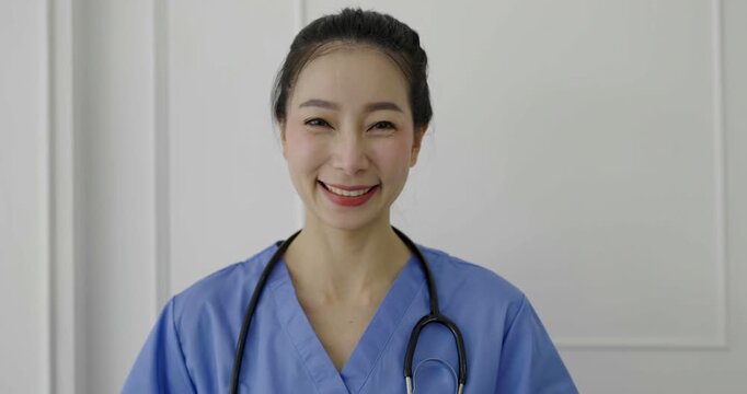 Female asian doctor using laptop for online consultation in a medical office, representing telemedicine, healthcare communication, and virtual patient clinic care.