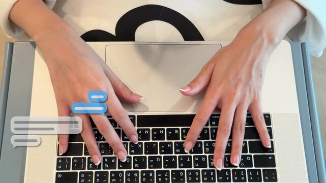 Top view 4K shot of an East Asian woman typing on her laptop keyboard with text pop-up message animations at her desk.