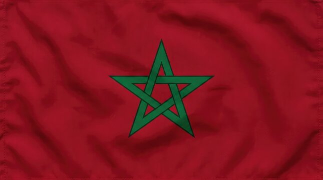 The flag of Morocco, a vibrant red banner with a green pentagram in the center, symbolizing unity and prosperity