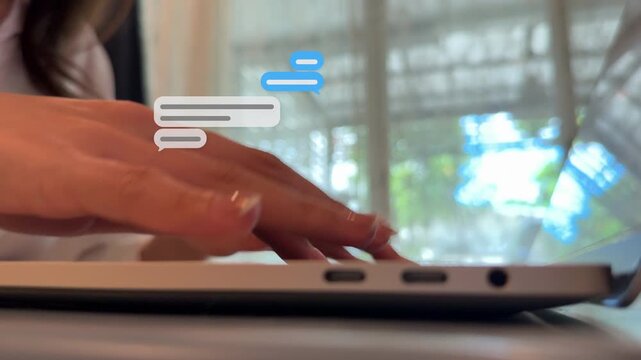 Low angle 16:9 4K shot looking up at an East Asian woman typing on her computer keyboard with message box animations.
