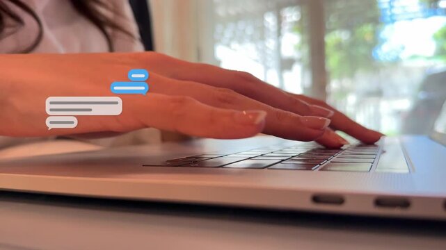 Panning 4K macro video of an Asian woman typing on her notebook with speech box graphics floating over the keyboard.