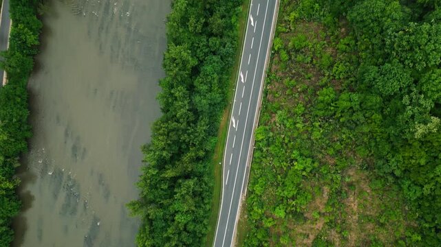 Aerial view of river canyon with road and low clouds