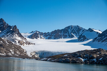 Snow covered mountains at Bjornfjorden, Svalbard, Norway © Angela