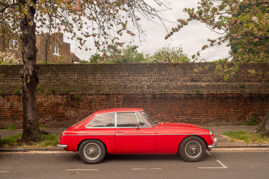 LONDON - APRIL 16, 2026: CHISWICK &ndash; classic red MG B GT sports car