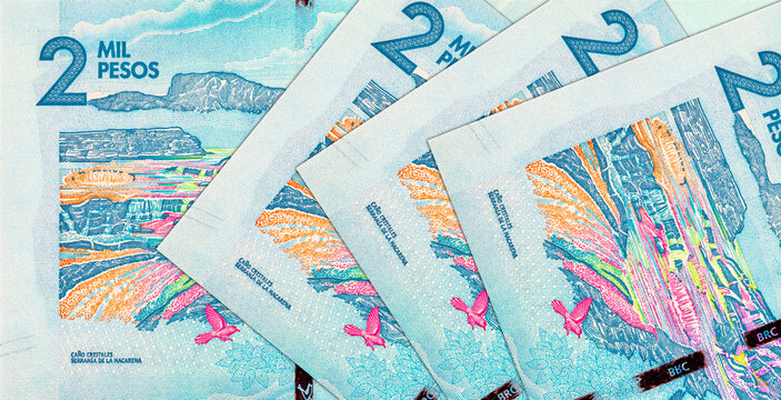 Colombian 2000 Mil Pesos banknote showing the Ca&ntilde;o Cristales river in Serrania de la Macarena and flying birds. Colombian national currency bill.