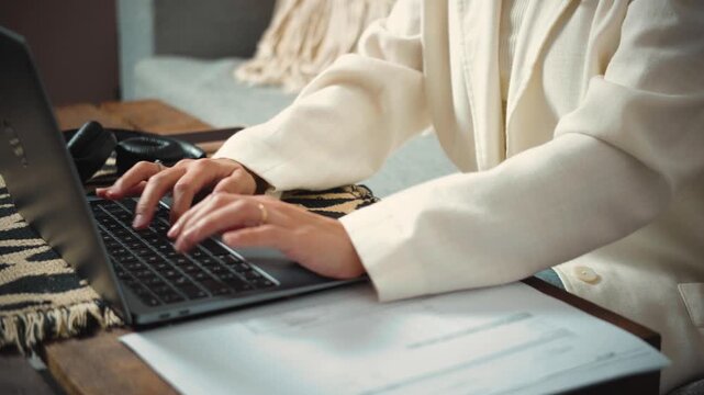 4K close-up video of an anonymous woman's hands using a laptop keyboard. Technology, remote work, productivity and digital communication concept.
