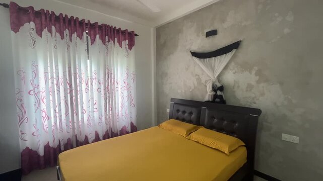 Stylish bedroom with yellow bed linen canopy net and elegant curtains.