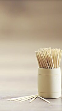 Sliding over toothpicks on wooden desk in studio