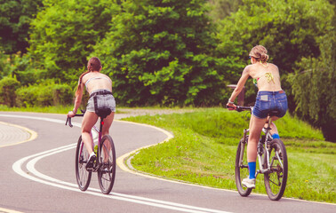 Fototapeta premium Cyclists ride on the bike path in the city Park