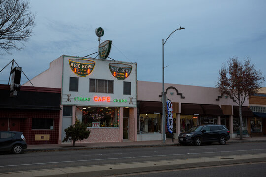 Neon signage at dusk at the Rice Bowl, historic Chinese restaurant dating back to the 1940s in Lompoc, California, December 2019