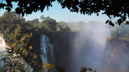 Victoria Falls in Zimbabwe displays water cascades and mist on a sunny day © Dave