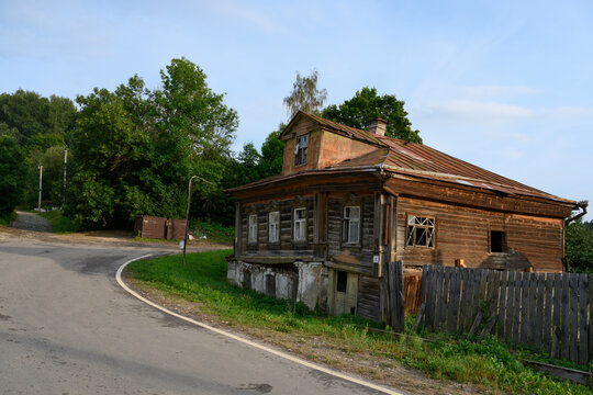 An old abandoned dilapidated wooden house of the 19th century at the turn of the road in Ples, Russia