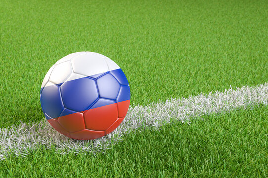 Football / soccer ball with a flag overlay of Russia on a football pitch background. International match and national team of Russia concept
