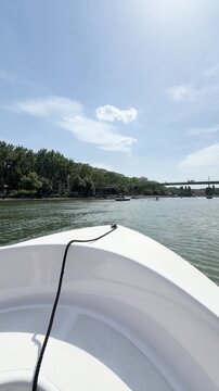 View from boat deck sailing along the Seine river in Paris on a sunny day