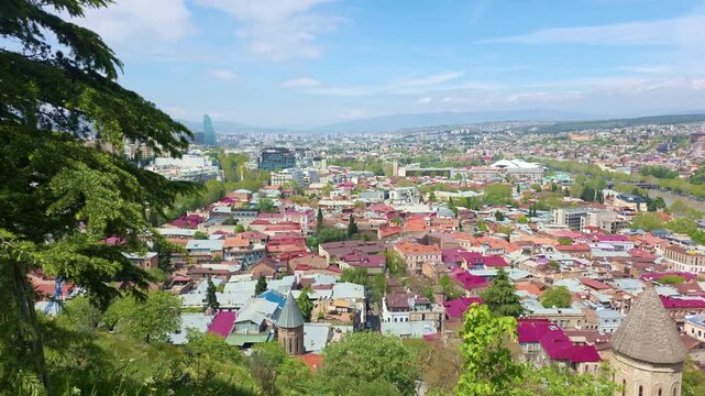 Panoramic view of Tbilisi, Georgia, captured from an elevated viewing platform near Narikala Fortress. The footage shows the historic old town.