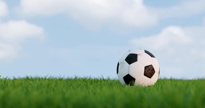 Soccer Ball Bouncing and Rolling on Green Grass against Blue Sky