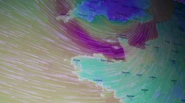 Dynamic wind anomaly over France, Bretagne and the UK British Channel shown as a camera shot of a computer screen with pixels visible featuring atmospheric flow, climate data and severe weather visual
