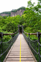 Fototapeta premium Wooden suspension bridge at Jianmen Pass, Sichuan, China