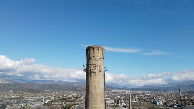 Aerial View Revealing a Large Old Industrial Factory Plant and Concrete Chimney