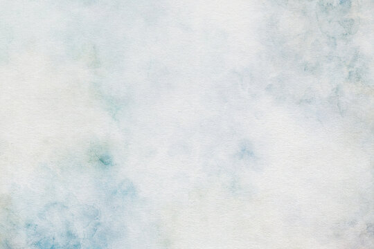 Watercolor abstract background with very soft blue cloudy tones. Minimal artistic texture feels light and airy and perfect for elegant layouts or stationery.