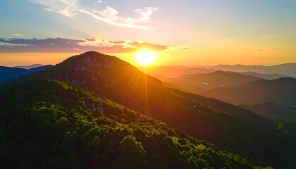 Obraz premium Golden Mountain Sunrise Glowing Over Layered Hills at Dawn