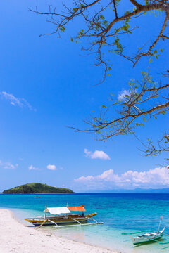 Tropical white sand on a sunny day at Alad Island. Romblon, Philippines