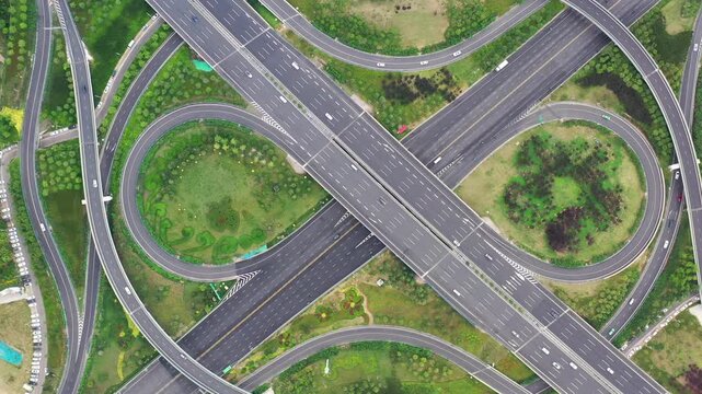 Aerial Top View of Curved Highway Interchange with Green Landscaping