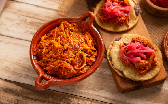 Cochinita Pibil. Typical Mexican stew from Merida, Yucatan, made from pork marinated with achiote and generally accompanied with beans and red onion with habanero chili, it can be eaten in tacos.