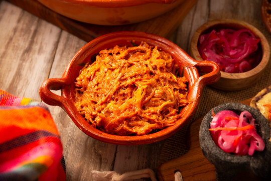 Cochinita Pibil. Typical Mexican stew from Merida, Yucatan, made from pork marinated with achiote and generally accompanied with beans and red onion with habanero chili, it can be eaten in tacos.