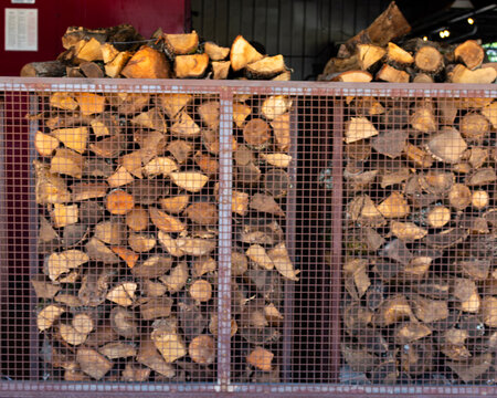 Two containers of fire wood at a barbecue smoke house restaurant. 