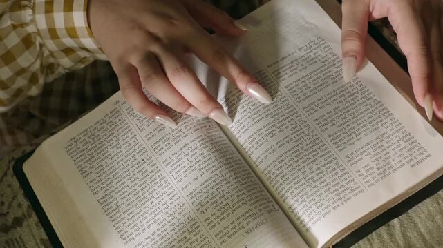 young conservative asian Woman Reading the Bible at table with bread food and drink indoors