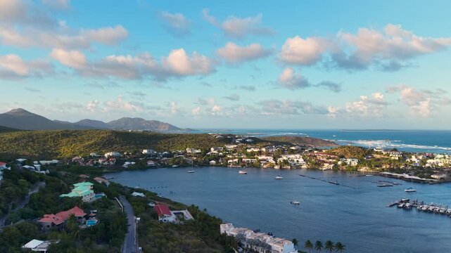 Aerial view of Oyster Pond on Saint Martin island in the Caribbean Sea. Coastal town with residential buildings and resort hotels is located on the border of French and Dutch sides. 