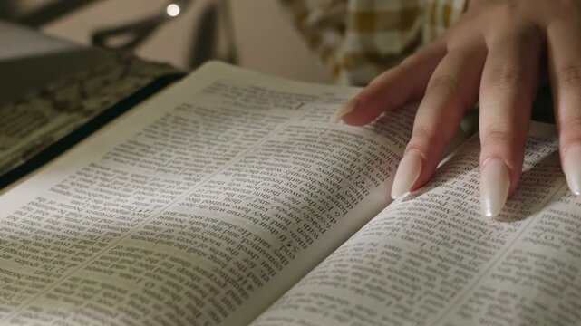 young conservative asian Woman Reading the Bible at table with bread food and drink indoors
