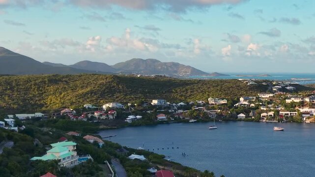 Aerial view of Oyster Pond on Saint Martin island in the Caribbean Sea. Coastal town with residential buildings and resort hotels is located on the border of French and Dutch sides. 