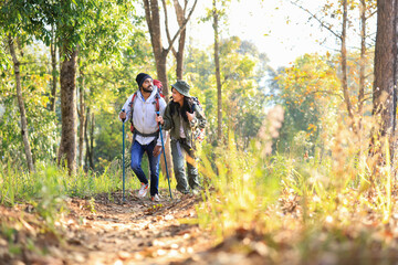 Fototapeta premium male backpacker traveling alone in forest wild. Attractive man traveler look around and explore world while walk in nature wood with happiness on outdoor holiday vacation trip.