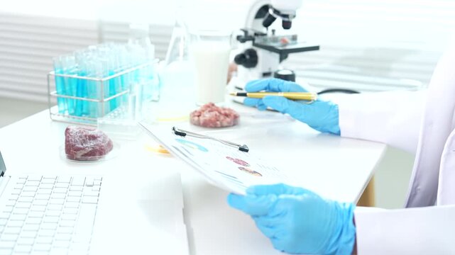 Food safety scientist testing meat, eggs, and biological samples in a laboratory, conducting contamination screening, microbiological analysis, and quality control procedures.